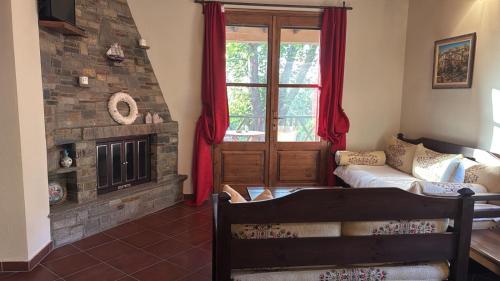 a living room with a couch and a window at Matias Kastanies Appartements with privat parking in Rachonio