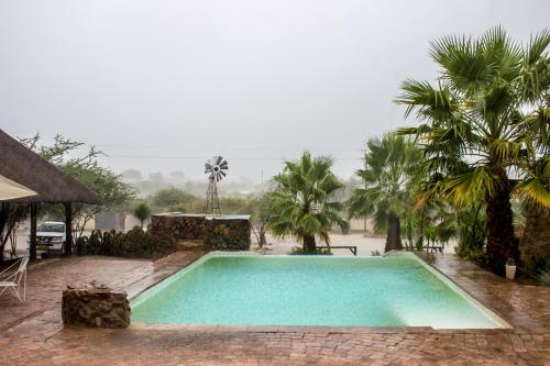 a swimming pool in the middle of a resort at Etotongwe Lodge in Outjo