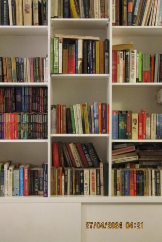 a book shelf filled with lots of books at Colombo 07 Charming Home Stays in Colombo