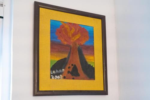 a framed painting of a tree with a house at Colombo 07 Charming Home Stays in Colombo