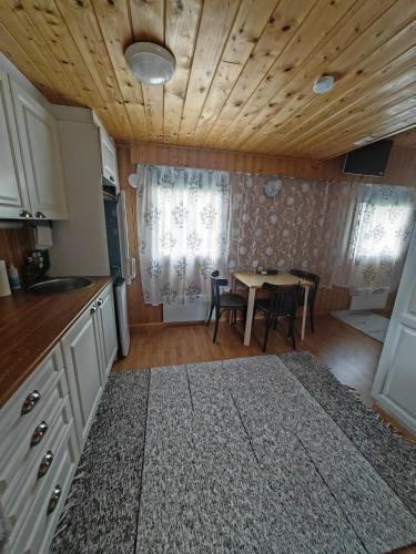 a kitchen and dining room with a table and chairs at Dream house in Savonlinna