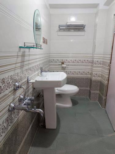 a bathroom with a sink and a toilet at Mawdong Homestay in Shillong