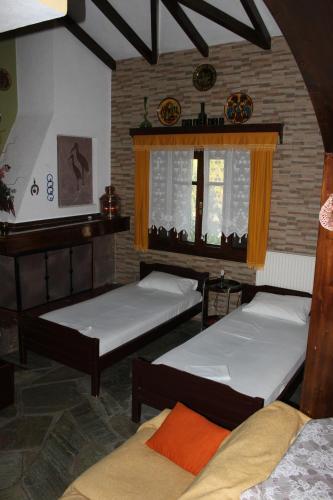 a room with three beds and a window at Garden House in Vourvourou