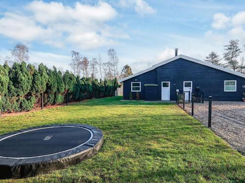 a building with a trampoline in front of a house at 12 person holiday home in Væggerløse-By Traum in Marielyst