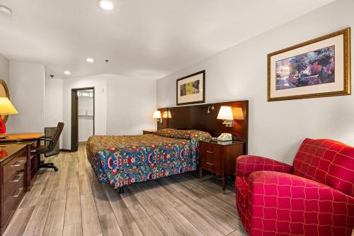 a hotel room with a bed and a desk and a couch at Paradise Lodge - Canoga Park, Los Angeles in Winnetka