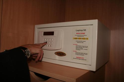 a person is pointing at a microwave on a counter at Espel in Andorra la Vella