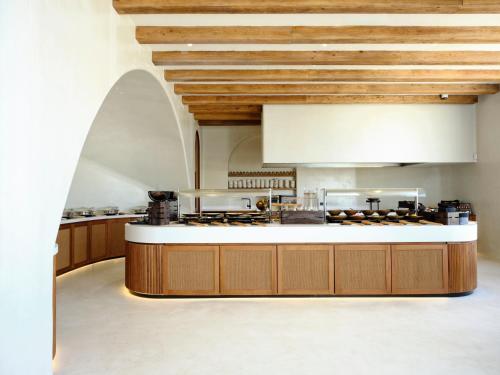 a large kitchen with a counter top in a room at Aya Resort - Adults Only in Ayia Napa