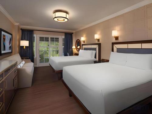 a hotel room with two beds and a sink at Disney's Yacht Club Resort in Orlando