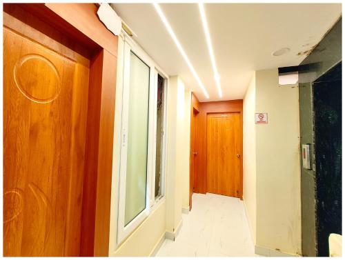 a room with a hallway with a window and a door at The BNK Heritage - Near Baba Vishwanath Temple and Ganga Aarti Ghat #Fully Air Conditioning #Lift #Wi-Fi - Room Service & Best Premium Hotel In Varanasi in Varanasi