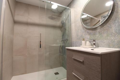 a bathroom with a shower and a sink and a mirror at Palatino Beach Albir in L'Alfas del Pi