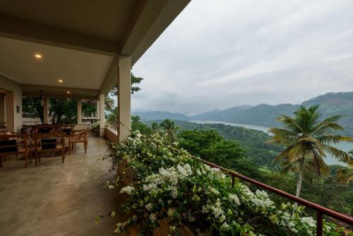 a balcony of a house with a view of the ocean at Golf Resort Par 3 in Kudadeniya