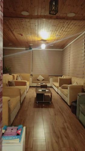 a living room with couches and a coffee table at La Mark Hostel in Wadi Musa