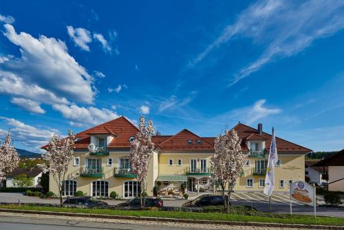 a large yellow building with a red roof at AKZENT Hotel Bayerwald-Residenz in Neukirchen
