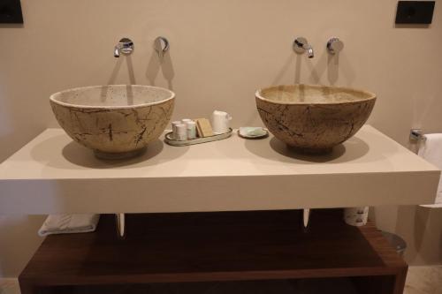 two bowls sitting on a counter in a bathroom at Agriturismo Radici by Miky in Monterosso al Mare