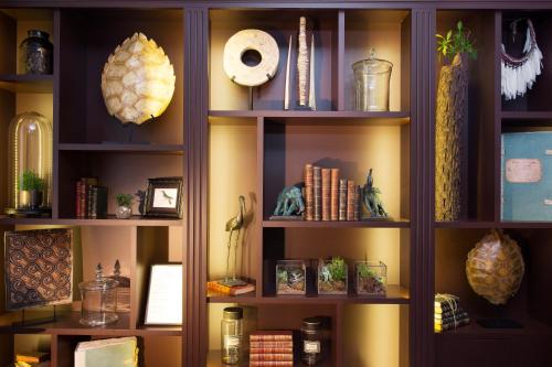 a book shelf filled with lots of books at Hotel Monge in Paris