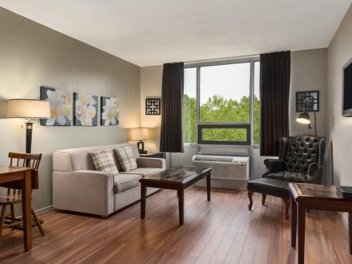 a living room with a couch and a chair at Travelodge by Wyndham Sydney in Sydney