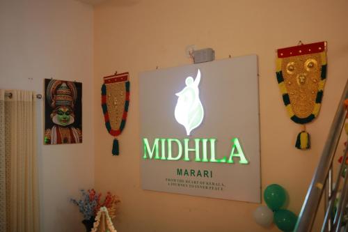 a sign on the wall of a room at Midhila Marari in Mararikulam