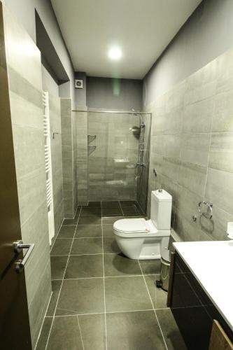a bathroom with a toilet and a glass shower at Hotel Story in Sarajevo