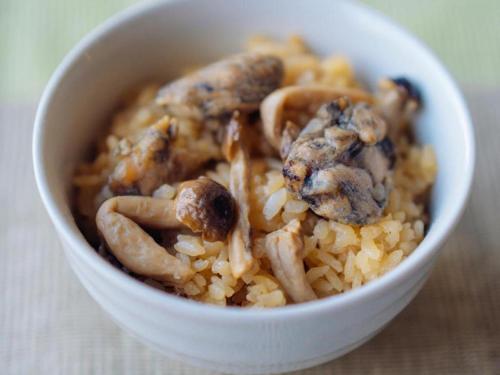 a white bowl filled with rice and mushrooms at Hotel Areaone Miyazaki in Miyazaki