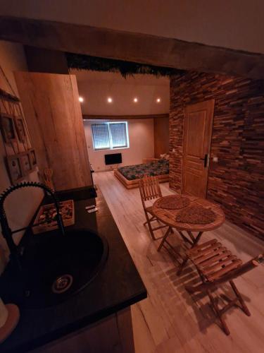 a large living room with a table and a couch at Ô Bonsaï Spa in Calais