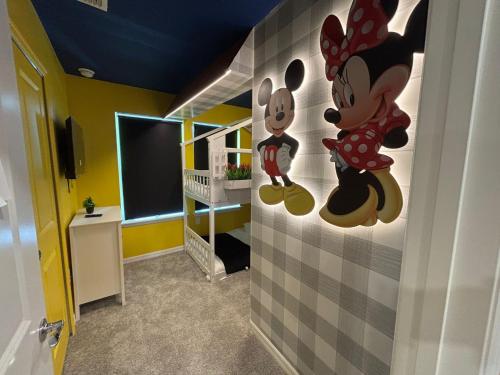 a room with a mickey mouse mural on the wall at 5 Bedrooms 45 Baths Windsor Cay 16146Cc in Clermont