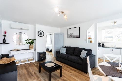 a living room with a couch and a table at Matahari Apartments and Villas in Upper Hutt