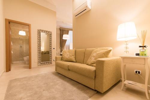 a living room with a couch and a mirror at Residenza Marchesi Pontenani in Florence