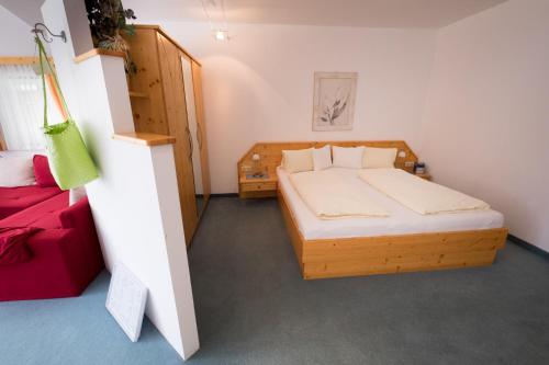a bedroom with a wooden bed in a room at Die Nockalm in Turracher Hohe