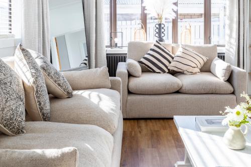 a living room with two couches and a coffee table at Matahari Apartments and Villas in Upper Hutt