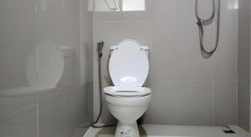 a bathroom with a white toilet and a shower at Station 203 Hotel in Bangkok