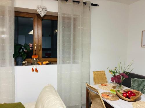 a dining room with a table with a bowl of fruit at Apartmán v Podhradí Boskovice in Blansko