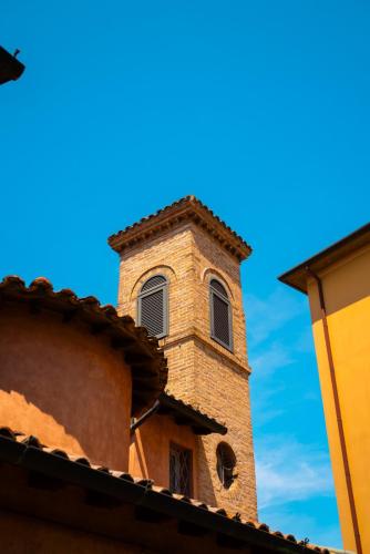 a clock tower on the side of a building at Ai Giardini di San Vitale in Ravenna