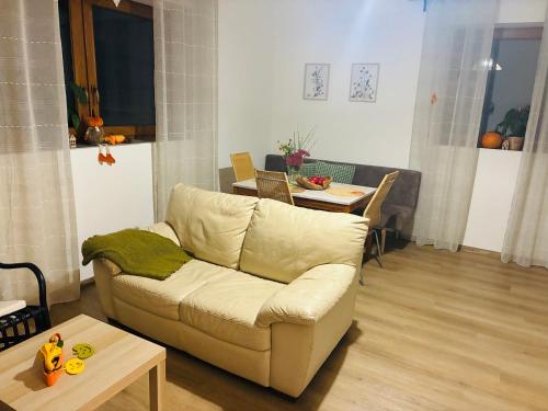 a living room with a white couch and a table at Apartmán v Podhradí Boskovice in Blansko