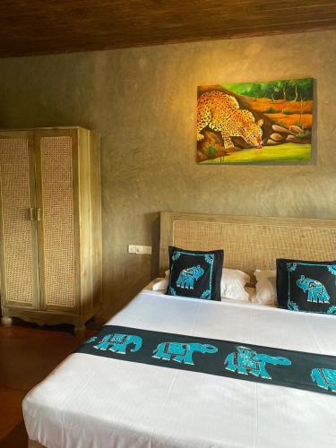 a bedroom with a bed with a painting on the wall at Negombo Boutique Villa in Negombo