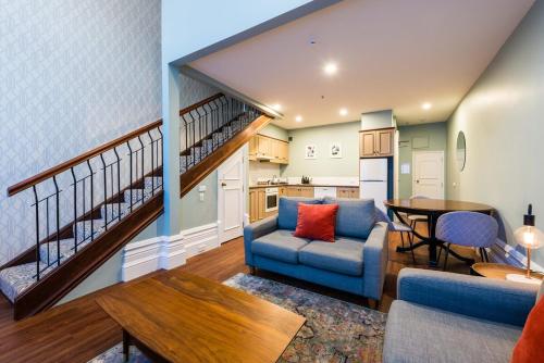 a living room with a couch and a table at 1 Bedroom Apartment Pool Car Park Cathedral Square in Christchurch