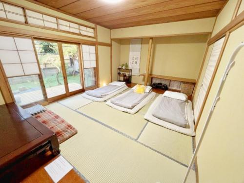 a room with three beds in a room at Japan Harry Potter 5min Walk Guesthouse 東京ハリーポッターまで徒歩5分の民宿 in Tokyo