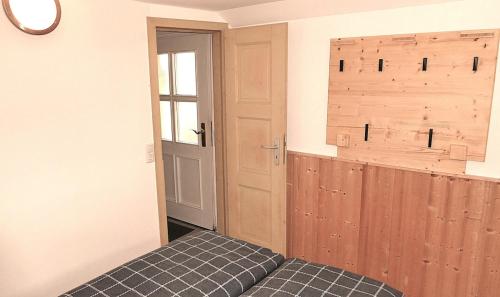 a room with a bed and a door and a window at Ferienhaus auf dem Land in Zell im Fichtelgebirge