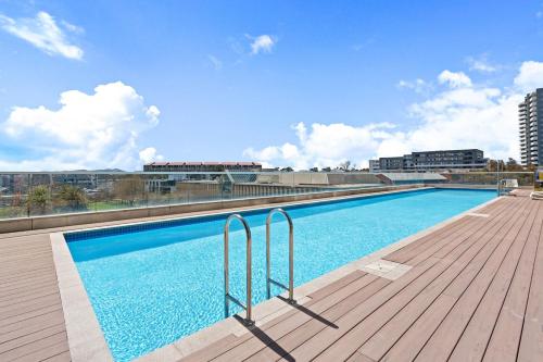 a large swimming pool on top of a building at 3BR 3BA Next to Mall & Govt Hub with Pool and Gym in Belconnen