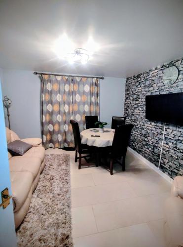 a living room with a couch and a table at High Rigg House Bradford - Luxury Accomodation with Private Parking in Idle