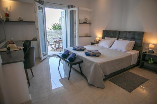 a bedroom with a large bed and a balcony at Galanos villa in Krotiri