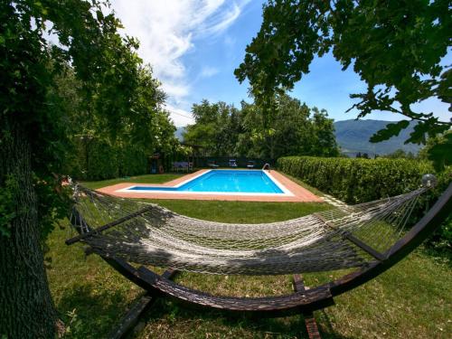 a hammock in a yard with a swimming pool at Mansion in San Valentino with Pool in San Valentino in Abruzzo Citeriore