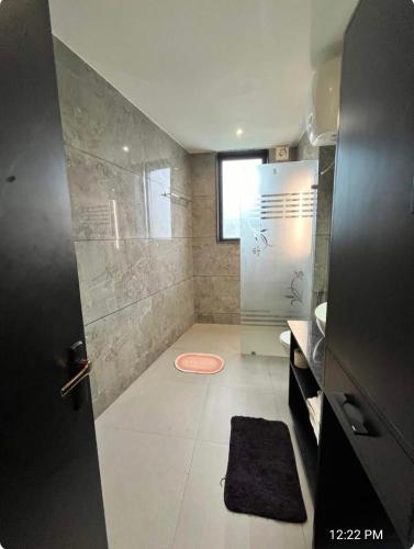 a bathroom with a shower and a sink at Khas Mahal Homestay in Agra