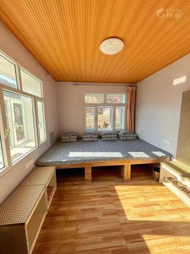 a large room with a large bed in it at Snow Valley Ruixueju Boutique B&B in Huolonggou