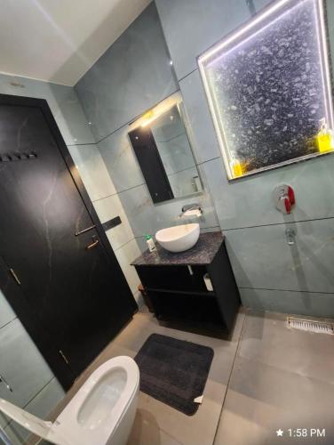 a bathroom with a toilet and a sink and a mirror at Khas Mahal Homestay in Agra