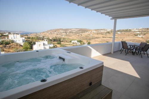 a hot tub on the balcony of a house at Galanos villa in Krotiri
