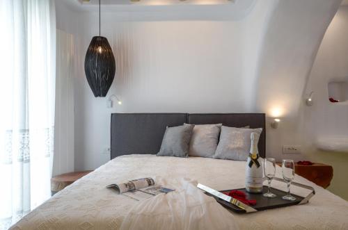 a bedroom with a bed with a tray on it at Naxos Island Escape Suites in Plaka