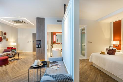 a hotel room with a bed and a living room at La Seine Hotel in Vientiane