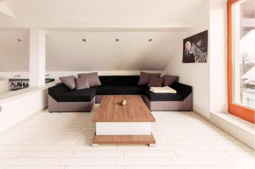 a living room with a couch and a coffee table at Apartment Mountain Sunrise in Škofja Loka