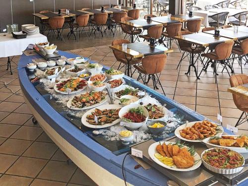 a buffet of food on a table in a restaurant at Faaborg Holiday Centre in Fåborg