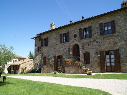 a large stone building with a grass yard at Holiday Home in Montone with Pool & Terrace in Montone